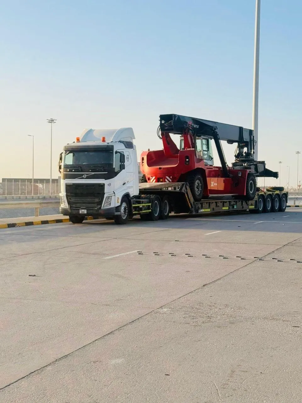 Kalmar reach stacker transported on a multi-axle low-bed trailer